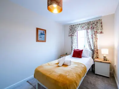 a bedroom with a bed with two towels on it at Pass the Keys 3 Bedroom home local to Ludlow town centre in Ludlow