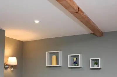 a room with three pictures on the wall with a ceiling at St John's Hill Apartments in Shrewsbury