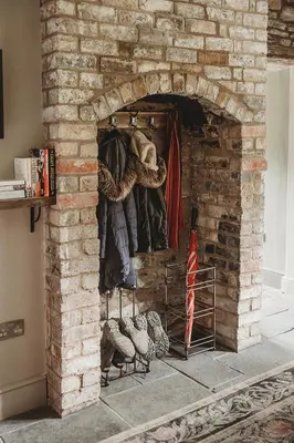a brick fireplace with a group of chickens in it at Ty Bach in Llanwrtyd Wells