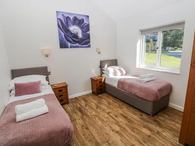 a room with two beds and a window at Dwrgi in Llanybydder