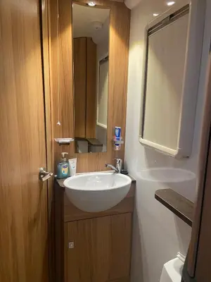 a bathroom with a white sink and a mirror at Hyssington Heights in Hyssington