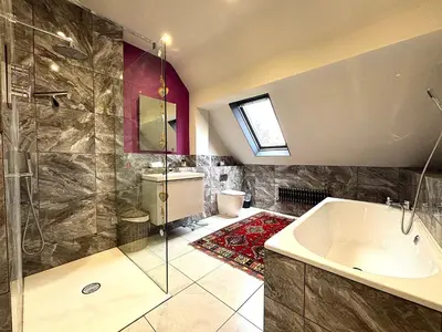 a bathroom with a tub and a glass shower at Spacious 4-Bed Home - Oswestry - Families & Groups in Oswestry