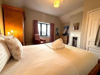 a bedroom with a bed with a pillow on it at Spacious 4-Bed Home - Oswestry - Families & Groups in Oswestry