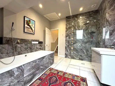 a large bathroom with a tub and a shower at Spacious 4-Bed Home - Oswestry - Families & Groups in Oswestry