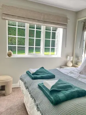 a bedroom with a bed with green pillows on it at Ty Newydd in Llangyniew