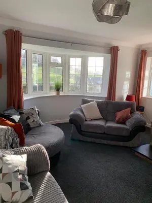a living room with a couch and a chair at Ty Newydd in Llangyniew