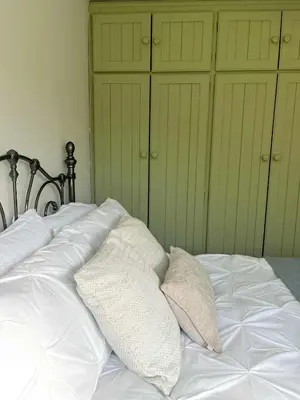 a white bed with two pillows on top of it at Ty Newydd in Llangyniew