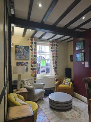 a living room with couches chairs and a table at Twin room - The Unicorn Hotel in Llanidloes