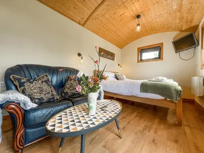 a living room with a couch and a bed at Blodwen - Ukc7016 in Corwen