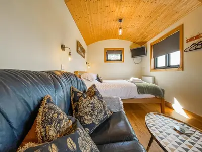 a living room with a couch and a bed at Blodwen - Ukc7016 in Corwen