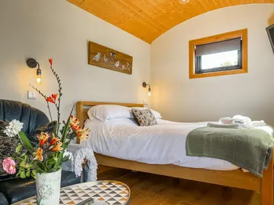 a bedroom with a bed and a couch at Blodwen - Ukc7016 in Corwen