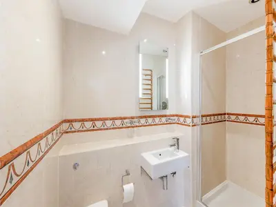 a bathroom with a sink and a mirror at The Penthouse Westhaven in Aberdyfi