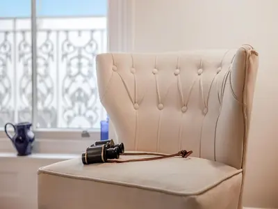 a camera sitting on a chair in a room at The Penthouse Westhaven in Aberdyfi