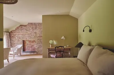 a bedroom with a bed and a desk and a chair at Mill House in Trefeglwys