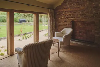 two chairs and a table in a room with windows at Mill House in Trefeglwys