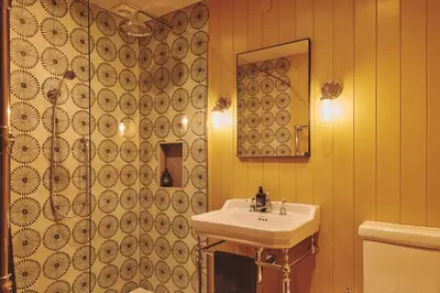 a bathroom with a sink and a mirror at Mill House in Trefeglwys