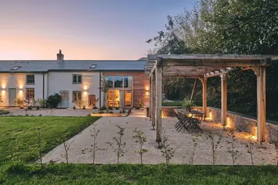a house with a pergola in front of it at Mill House in Trefeglwys