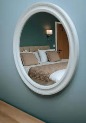 a bedroom with a bed in a mirror at Beacons View Luxury Lakeside Chalet- Trem Y Fan in Brecon
