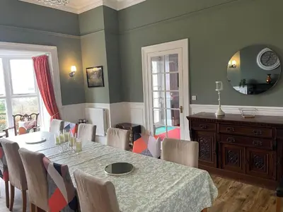 a dining room with a table and chairs at Noddfa Country House in Harlech