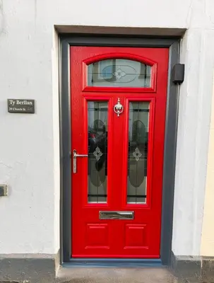 a red door with a window on a building at Charming 2 bedroom cottage in Brecon - families and pets welcome! in Brecon