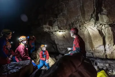 a group of people sitting in a cave at Traditional Welsh Longbarn in Aber-Brân