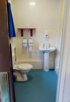 a bathroom with a toilet and a sink at Traditional Welsh Longbarn in Aber-Brân