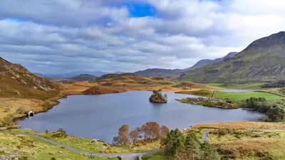 a large lake in the middle of a mountain at Finest Retreats - Pandy Farmhouse in Dolgellau