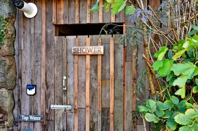 a wooden fence with a sign that says shower at Finest Retreats - Pandy Mongolian Yurt in Dolgellau
