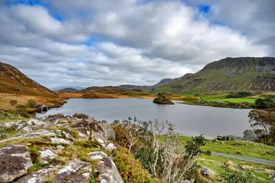 a lake in the middle of a mountain at Finest Retreats - Pandy Mongolian Yurt in Dolgellau