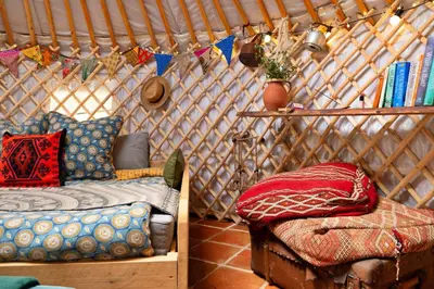 a room with a bed and a couch in a yurt at Finest Retreats - Pandy Mongolian Yurt in Dolgellau