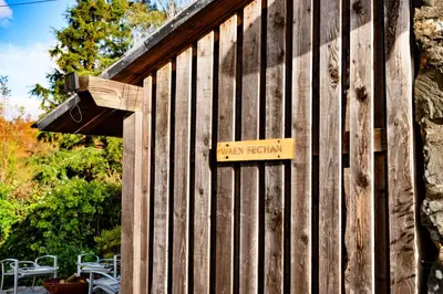 a wooden fence with a sign on the side of it at Finest Retreats - Waen Fechan in Dolgellau