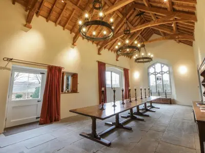 a large room with a table in the middle at West Cottage in Llandovery