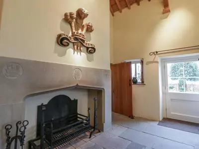 a room with a fireplace with a statue on the wall at West Cottage in Llandovery