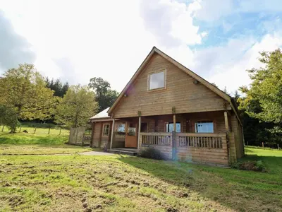 a large wooden house in a field at Dan Y Coed in Presteigne