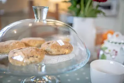 a glass plate with donuts on a table at Beudy-Talsarnau in Talsarnau