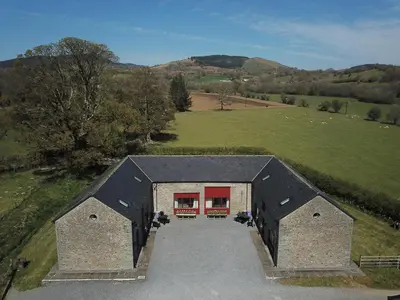 an overhead view of a building with red doors at Hobby Stable Cottage in Cynghordy