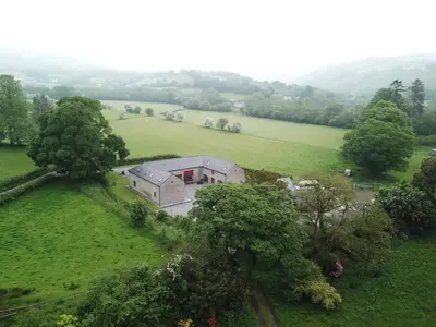 an aerial view of a house in a field at Hobby Stable Cottage in Cynghordy