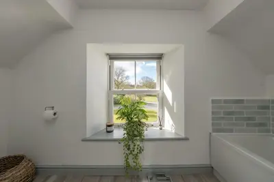 a plant sitting on a window sill in a white room at Cefn-Y-Maes in Dolgellau