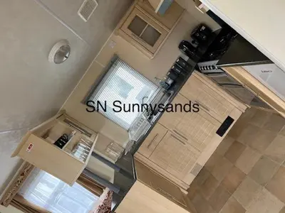 an aerial view of a kitchen with a large window at Lyons Sunnysands - Sandy Cove 50 in Llanddwywe