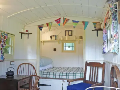 a small room with a bed in a tiny house at Cwt Cwtshlyd in Tregaron