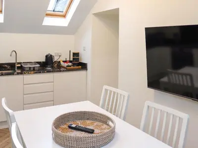 a kitchen with a white table with a basket on it at Apartment One - Uk49591 in Bala
