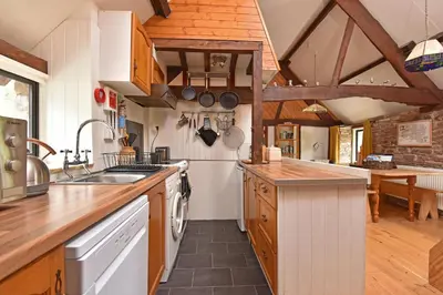 a kitchen with a sink and a counter top at The Hayloft at Cwmffrwd Farm in Cathedine