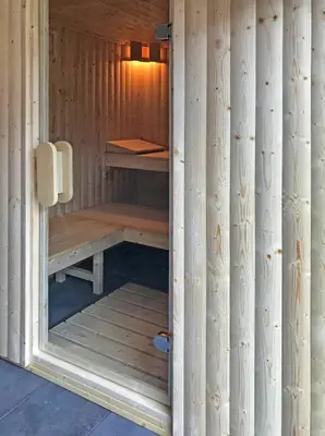 a wooden sauna with a bench in the middle at The Hand at Llanarmon in Llanarmon Dyffryn-Ceiriog