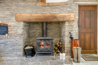 a stone fireplace with a wood stove in it at 4 Bed in Peterchurch oc-s34019 in Peterchurch