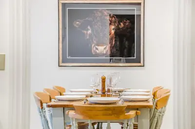 a table with chairs and a picture of a horse at 4 Bed in Peterchurch oc-s34019 in Peterchurch