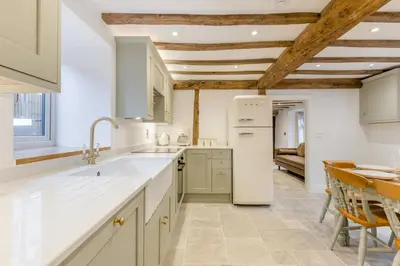 a kitchen with a white refrigerator and a table at 4 Bed in Peterchurch oc-s34019 in Peterchurch