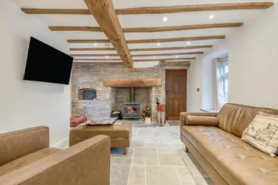 a living room with a couch and a fireplace at 4 Bed in Peterchurch oc-s34019 in Peterchurch