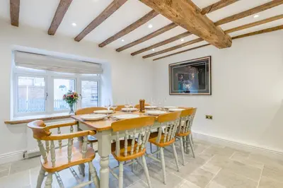 a dining room with a wooden table and chairs at 4 Bed in Peterchurch oc-s34019 in Peterchurch