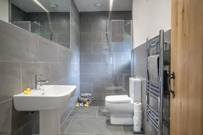 a bathroom with a white toilet and a sink at Y-Ddol in Dyffryn