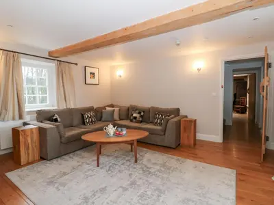 a living room with a couch and a table at Secret Garden Cottage in Lampeter